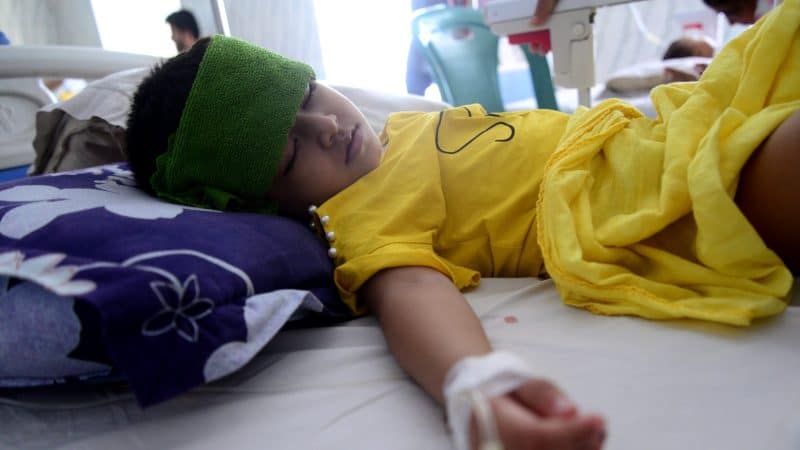 A child suffering from fever and muscle pains