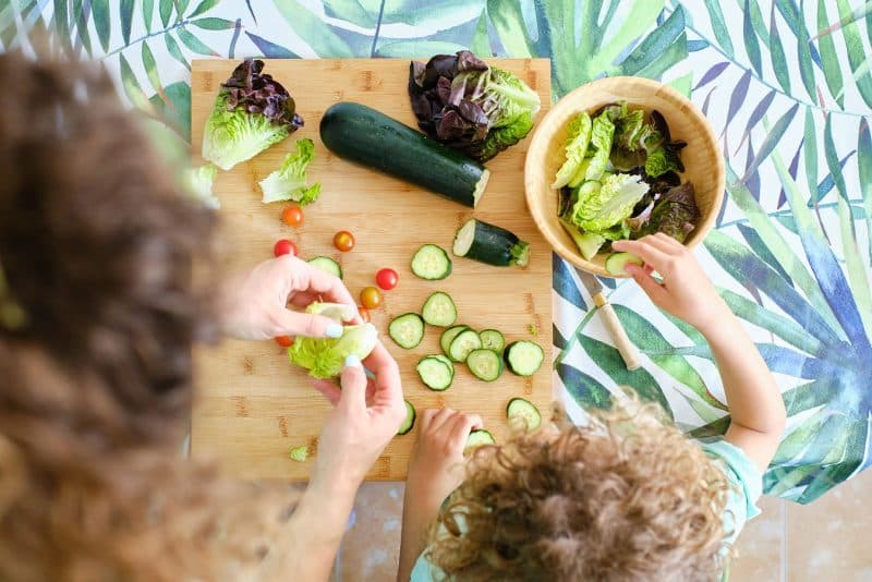 A parent teaching her child how to eat the right foods