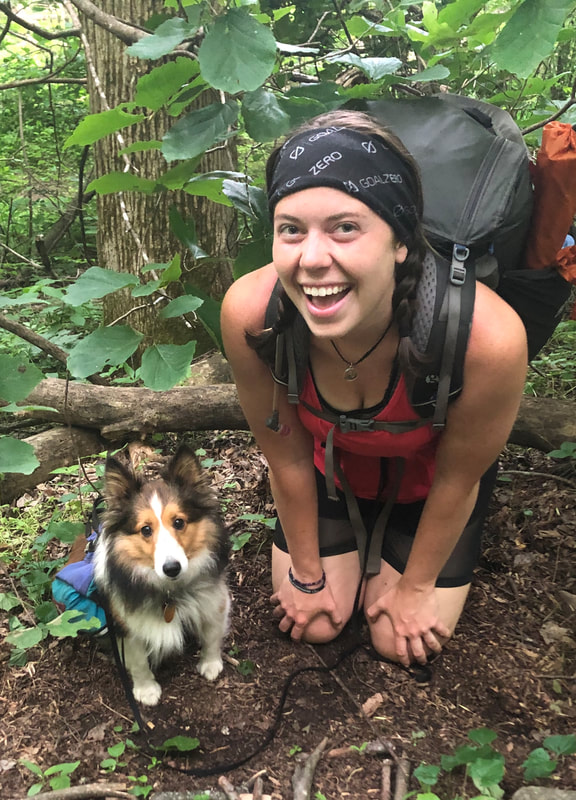 A girl hiking with her cute dog, protected from ticks